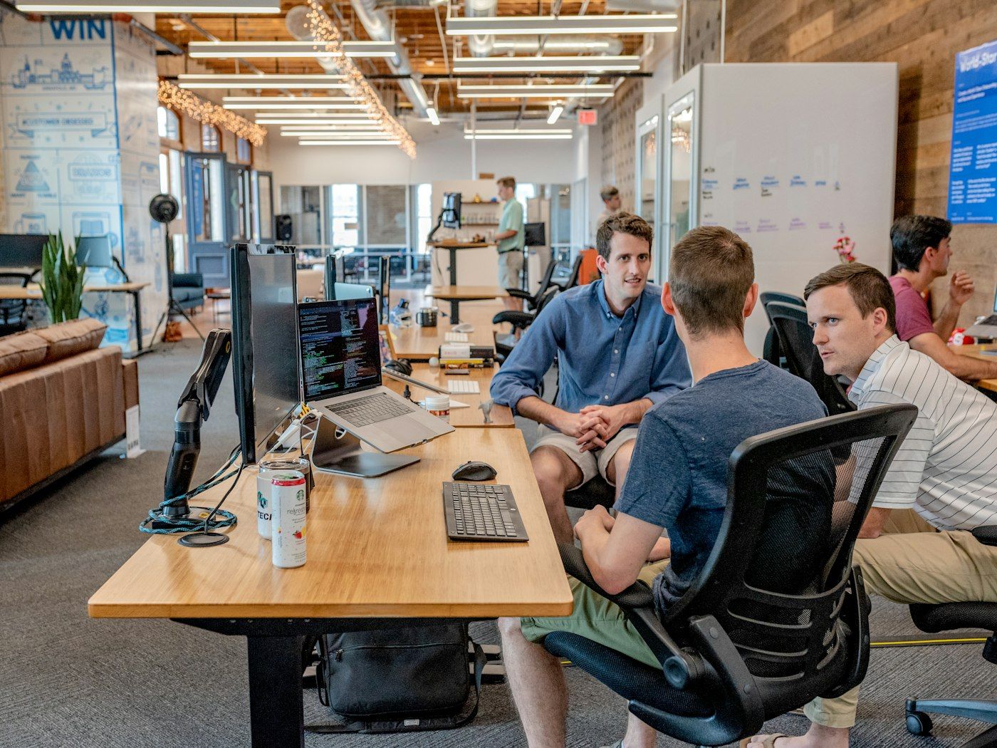 team discussing strategy around a laptop
